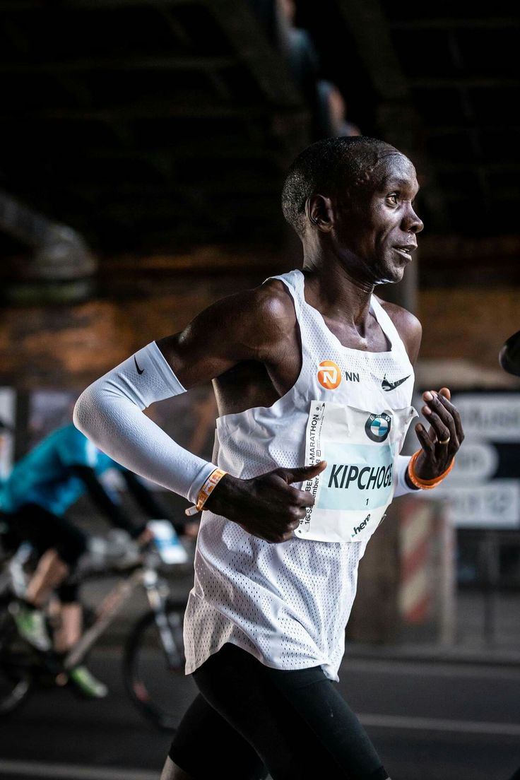 a man running in a race with other bicyclists behind him