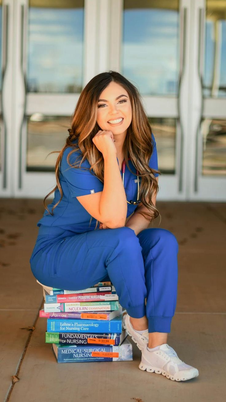 a woman sitting on top of a stack of books