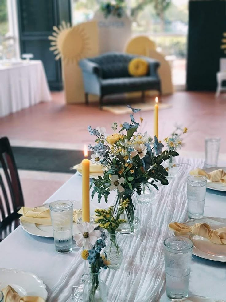 the table is set with candles and plates