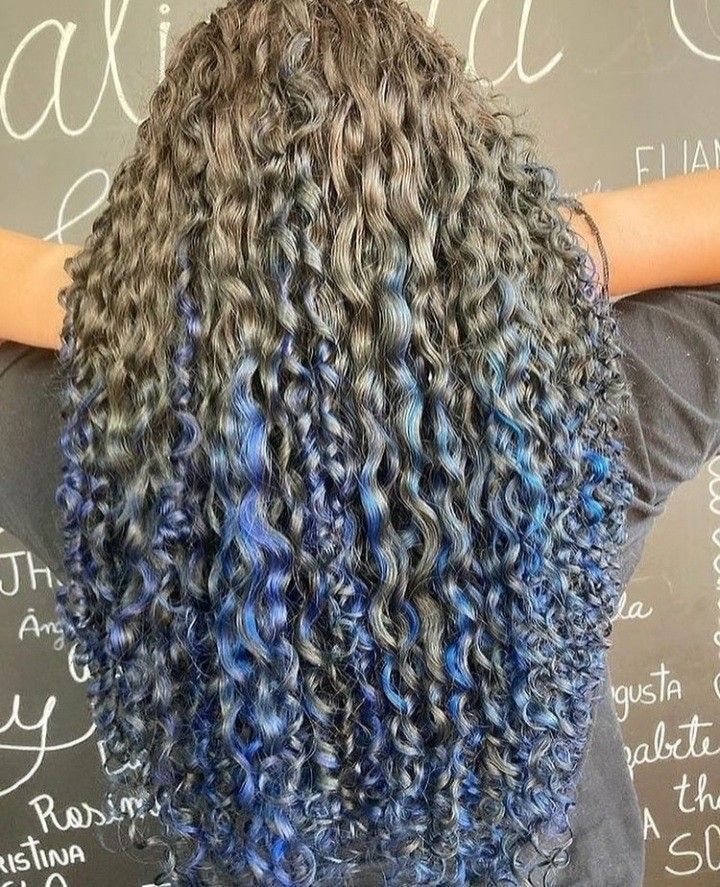 Stunning Blue Highlights for Every Hair Color Curly Hair With Blue Streaks, Brown Curly Hair With Blue Highlights, Black And Blue Hair Curly, Dyed Curly Hair Ideas Colour Blue, Curly Blue Highlights, Blue Highlights In Brown Hair Curly, Curly Hair With Blue Highlights, Blue Highlights Curly Hair, Blue Highlights In Brown Hair