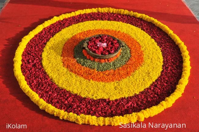 an arrangement of flowers arranged in the shape of a flowerpot on a red carpet