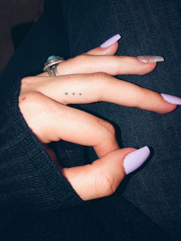 two hands with pink and white nail polish holding each other's fingernails