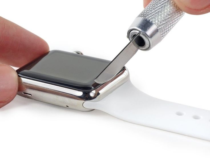 someone is removing the screen from their apple watch