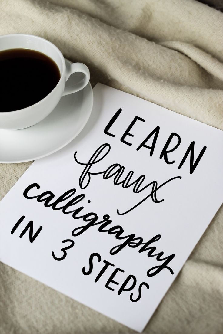 a cup of coffee sitting on top of a table next to a sign that says learn how to draw calligraphy in 3 steps