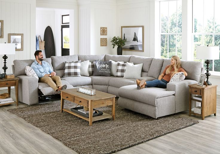 a man and woman sitting on a couch in a living room