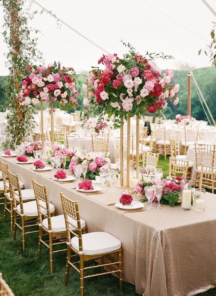 the tables are set with pink and white flowers