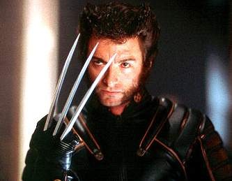 a man dressed as wolverine holding up his claws