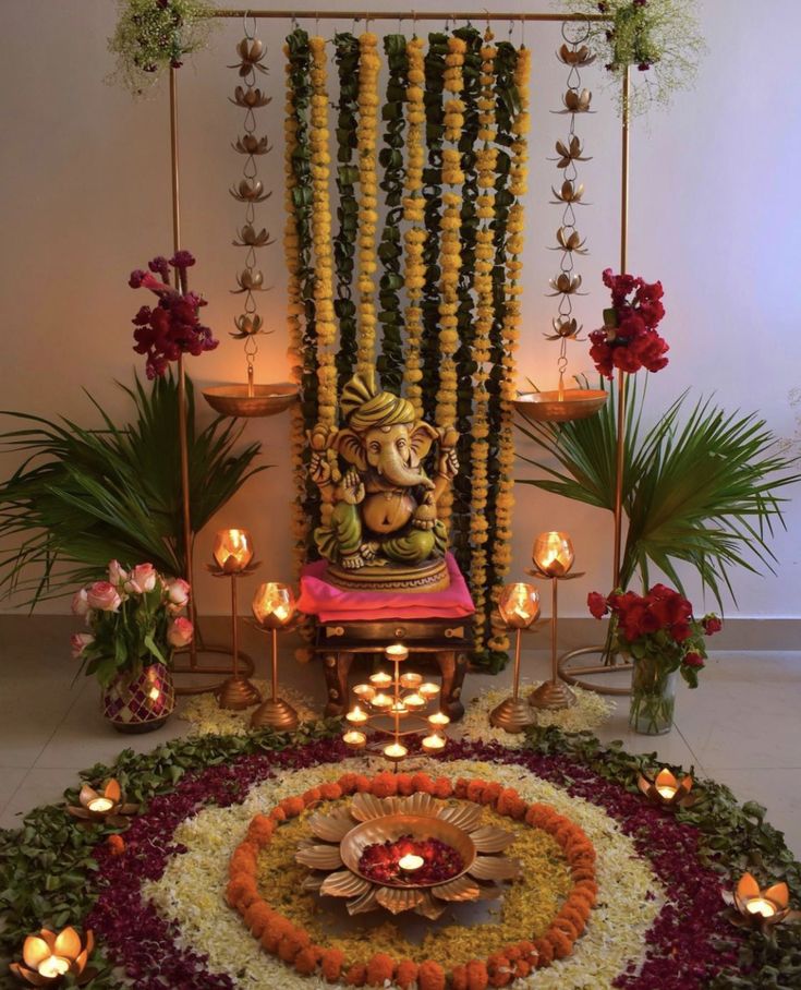 an image of a decorated stage with candles and flowers on the floor for diwaling