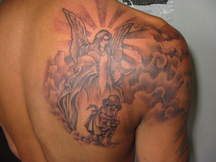 the back of a man's shoulder with an angel tattoo on his upper half