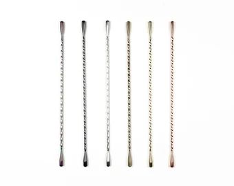 four different types of knitting needles on a white background