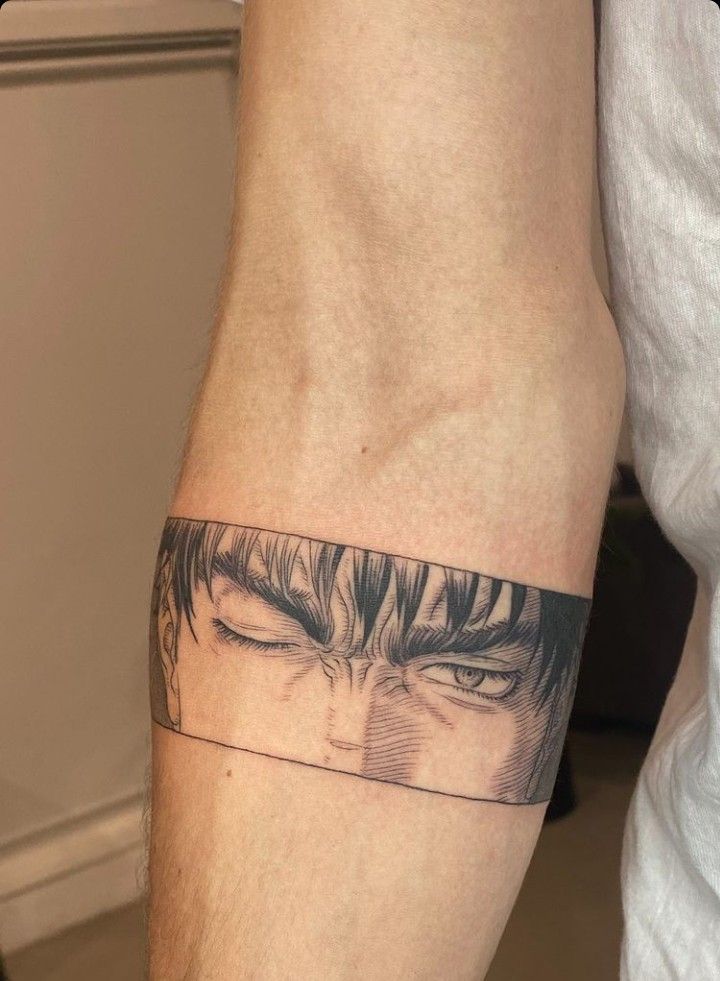 a man's arm with an anime tattoo on it