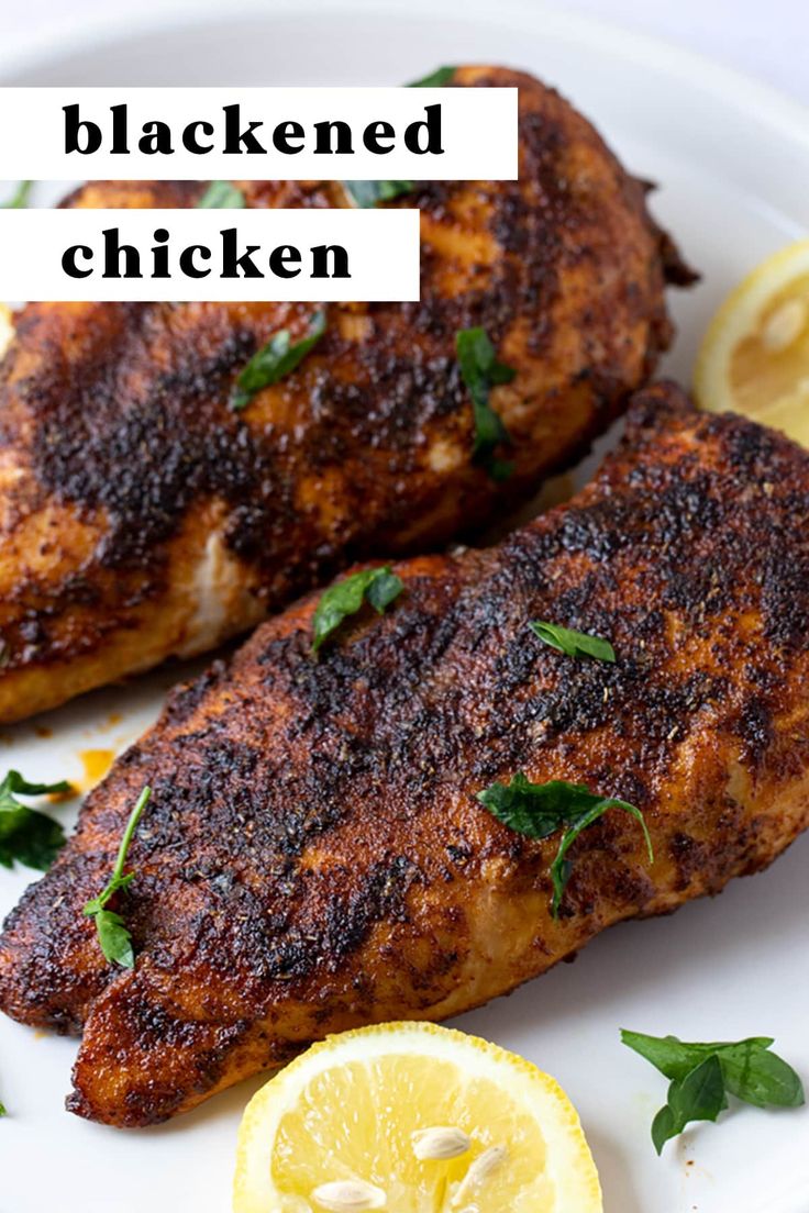 grilled chicken on a white plate with lemons and parsley sprigs