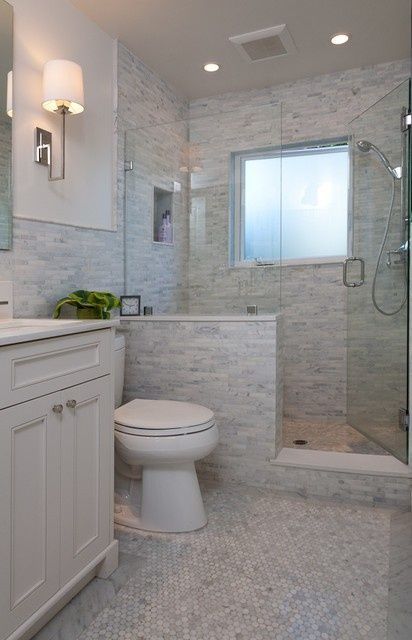 a bathroom with a toilet, sink and shower