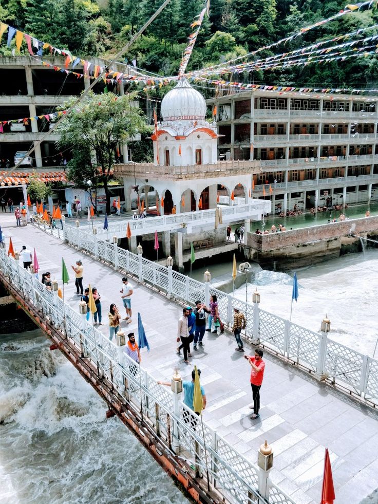 many people are walking across a bridge over water