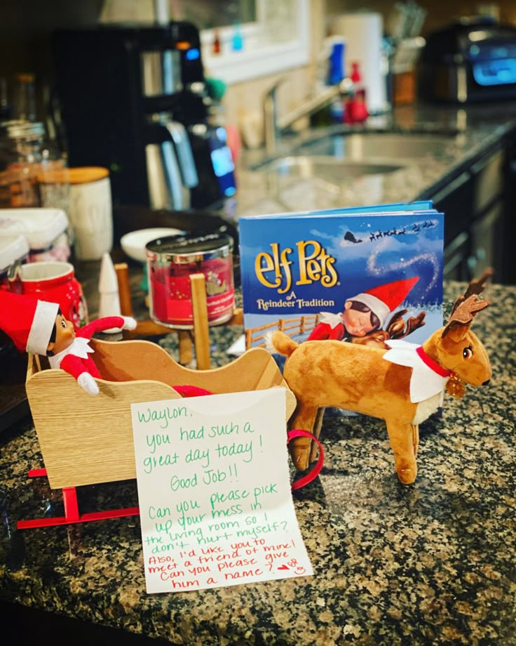 an elf's sleigh and reindeer on a kitchen counter