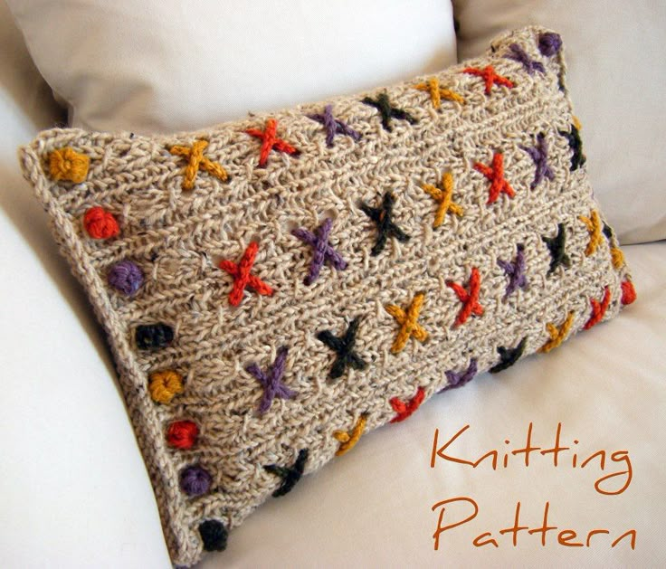 a crocheted pillow is sitting on a white bed with the words knitter written below it