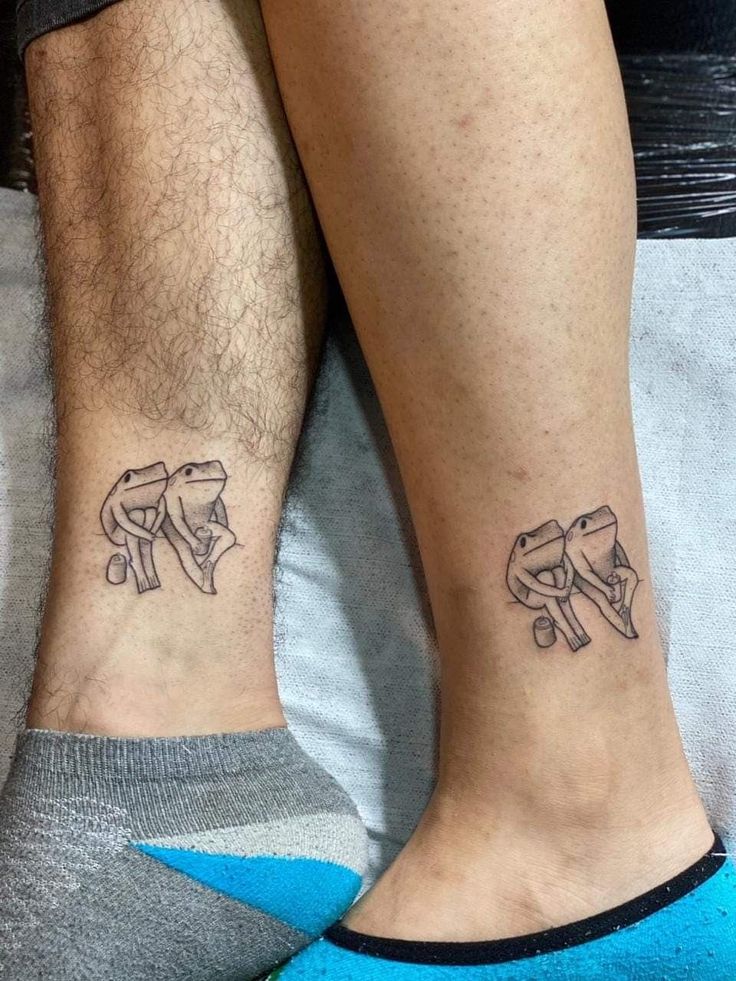 two people with matching tattoos on their legs