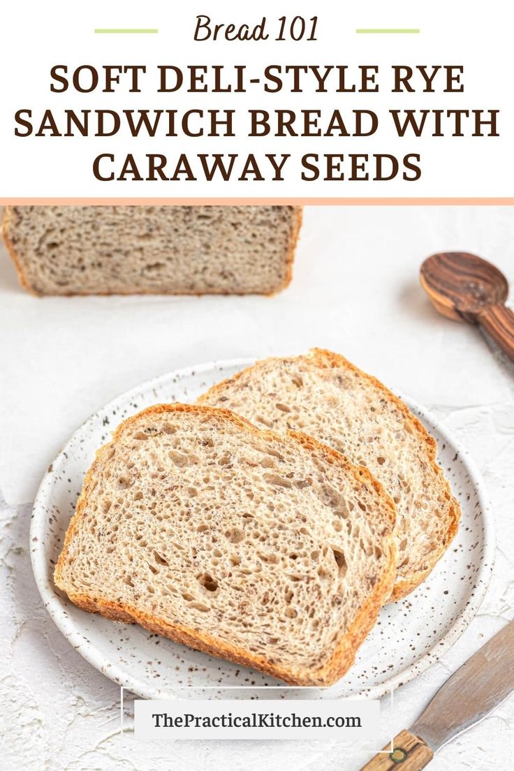 two slices of soft deli - style rye sandwich bread with caraway seeds on a white plate