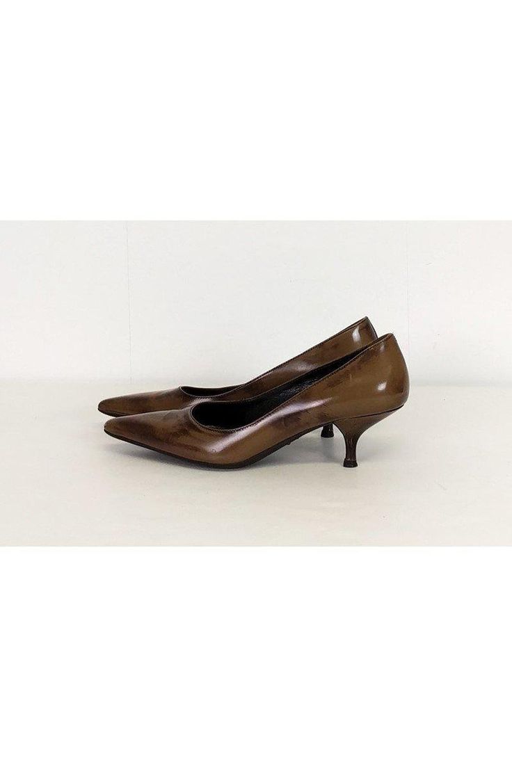 Luxe brown heels with a kitten heel and pointed toe silhouette. Great for the office, add a pencil skirt and tailored blouse to complete a work appropriate look. Size 6 (EU 36) Leather upper & synthetic sole Made in Italy Pointed toe Kitten heel Slip on Light outsole wear Scuff on front of left toe Heel height 2.5" Sleek Fitted Kitten Heels With Pointed Toe, Fall Fitted Kitten Heels With Sculpted Heel, Fitted Kitten Heels For Spring Workwear, Spring Workwear Fitted Kitten Heels, Pointed Kitten Heels For Office, Fall Workwear Kitten Heels With Sculpted Heel, Fall Kitten Heels With Sculpted Heel For Work, Fitted Heels With Round Toe For Office, Pointed Toe Kitten Heels For Office