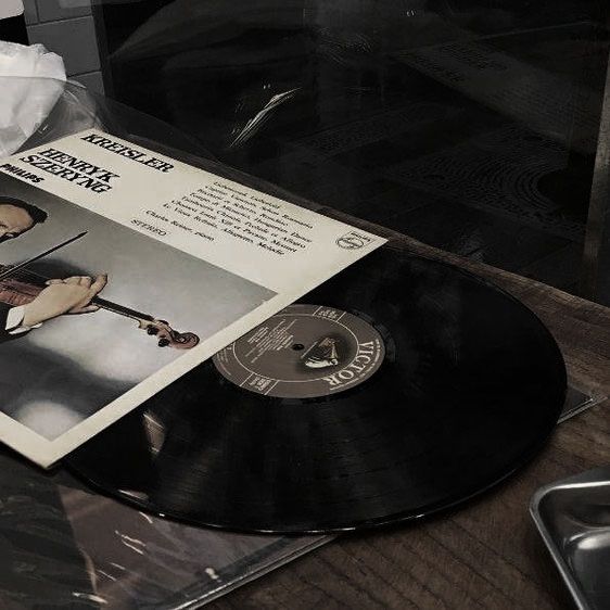 a black and white photo of an album with a violin on it's cover