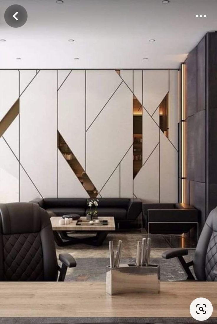 a living room filled with black and white furniture next to a wall mounted flat screen tv