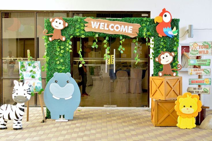 an animal themed welcome sign is displayed in front of the entrance to a children's play area