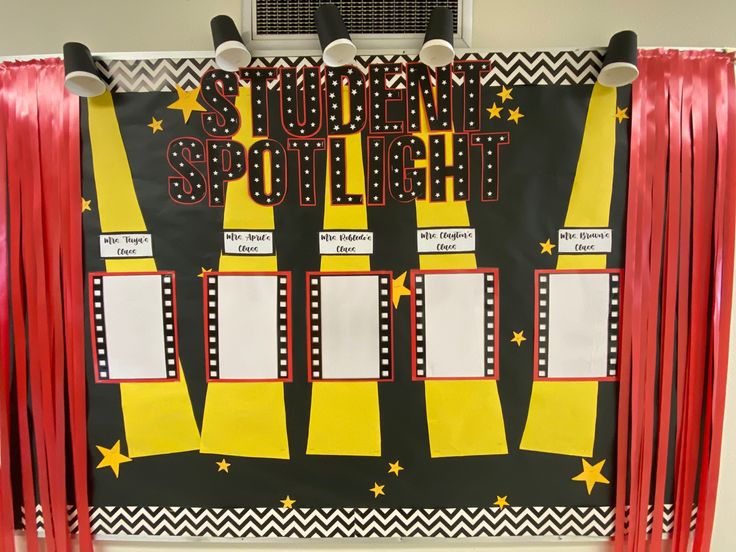 a bulletin board with red tassels and black and yellow writing that says student spotlight