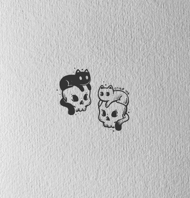 two stickers with cats on them sitting next to each other in front of a white wall