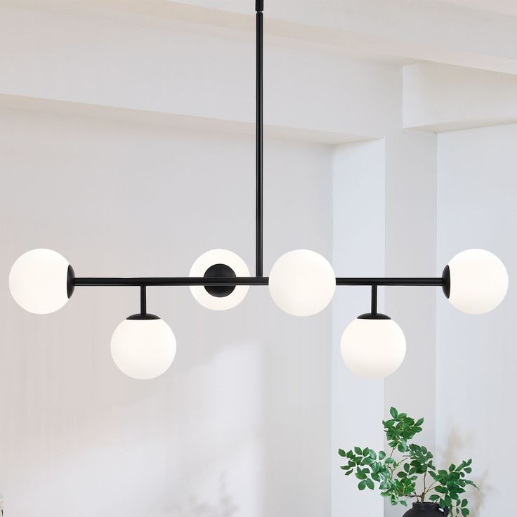 This 6-Light sputnik modern Linear chandelier pendant light is a great blend of modern classic and transitional styles. It's shaped in modern linear and glass globes , featuring matte black finish and white frosted opal glass shades, , which looks low-profile but has the elegant and minimalist aesthetics. The glass sphere hanging light is an eye-catching and focal piece to help complete a timeless interior decor, is ideal for over kitchen island and dining room table, or in a living room and hot Pendant Lights Over Dining Table, Modern Chandelier Foyer, Modern Black Chandeliers, Modern Linear Chandelier, Signal Hill, Dining Chandelier, Timeless Interior, Dining Room Pendant, Black Light Fixture