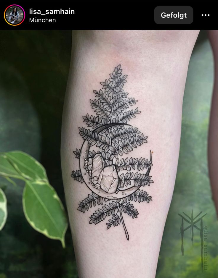 a tattoo on the leg of a woman with a pine tree and arrow in it