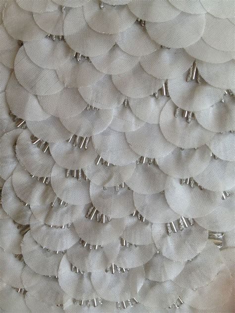 a white wall hanging with lots of circles on it's side and numbers in the middle