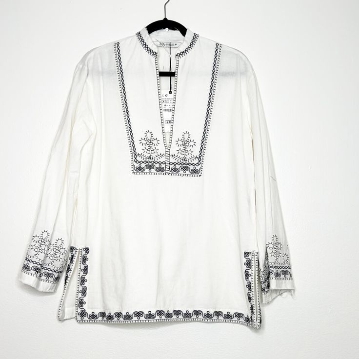 Zara Long Sleeve Tunic Embroidered With Black Designs. The Classic White Tunic. Split V Neckline With Embroidery. Pull On Style Relax Fit Frayed Hem Side Slits Runs Big Zara White Floral Embroidered Tops, White Embroidered Long Sleeve Top, White Embroidered Long Sleeve Blouse, White Embroidered Tunic Top, Zara Embroidered White Tops, Zara White Embroidered Tops, Zara Embroidered Cotton Blouse, White Embroidered Zara Tops, White Long Sleeve Blouse With Embroidered Hem