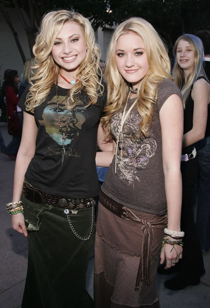 two beautiful young women standing next to each other