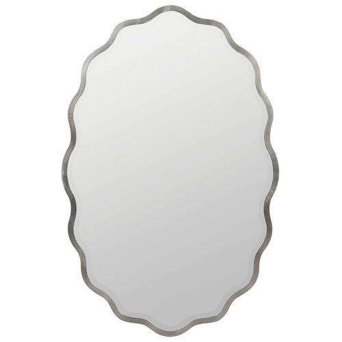 an oval shaped mirror with silver trimmings on the edges and a white background