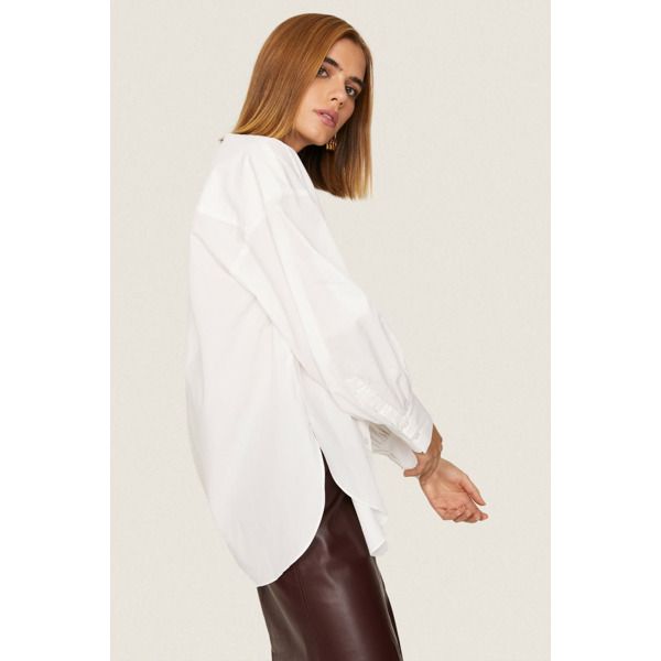 White poplin (100% Cotton). Top. Long sleeves. V-neck. Front button closure. 29" from shoulder to hemline. Imported. Chic Poplin Blouse For Daywear, Chic Daywear Poplin Blouse, Oversized V-neck Blouse With Button Closure, Daywear Poplin Blouse With Button Cuffs, Fall Poplin Shirt, Daywear Poplin Tops With Button Closure, Daywear Tops With Button Closure, Long Sleeve Poplin Blouse For Daywear, Classic Poplin Tops For Fall