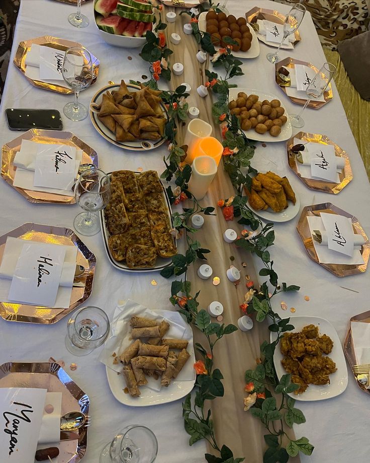 a long table is set up with plates and silverware for an elegant dinner party