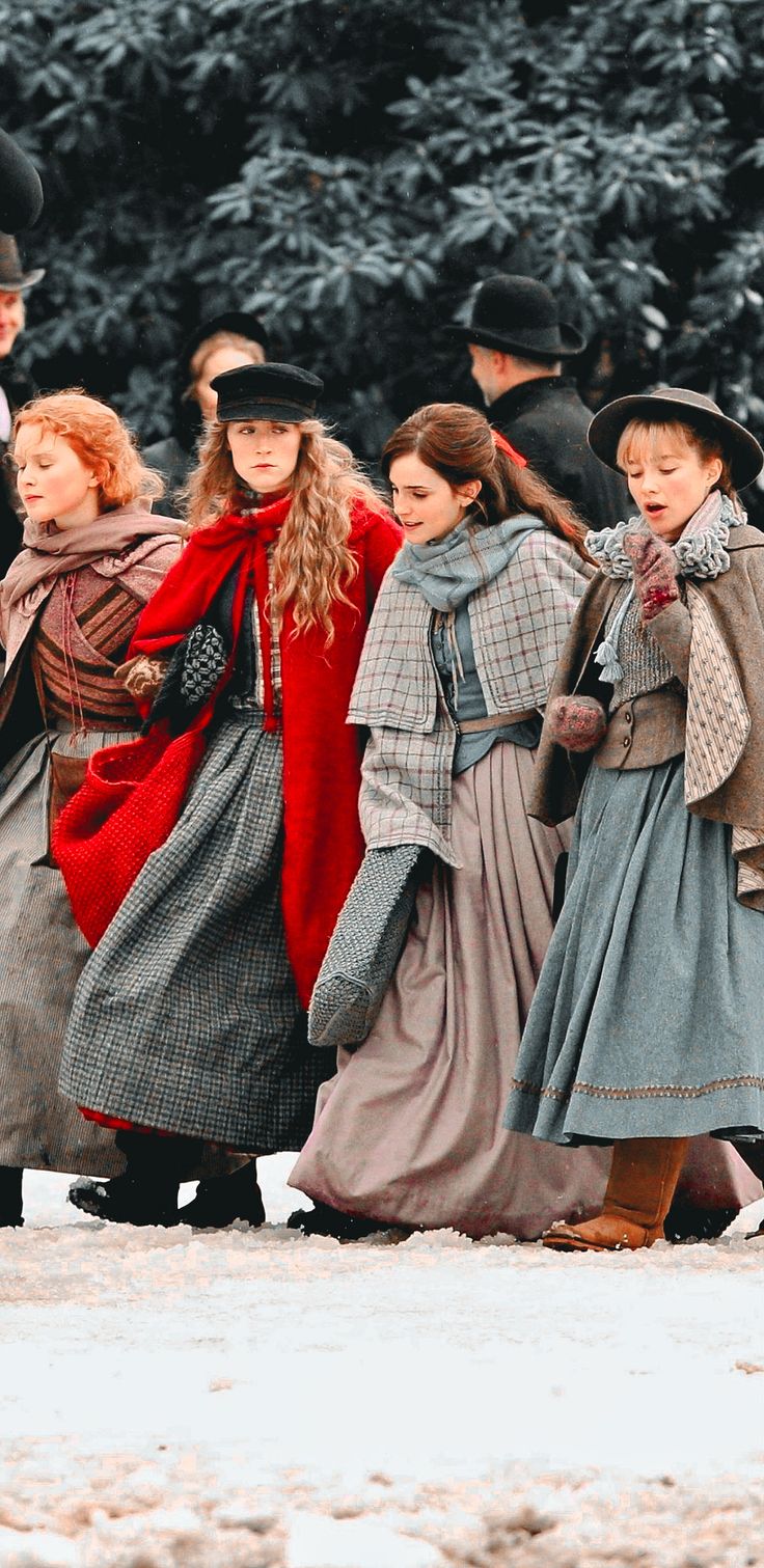 several people dressed in period clothing walking together