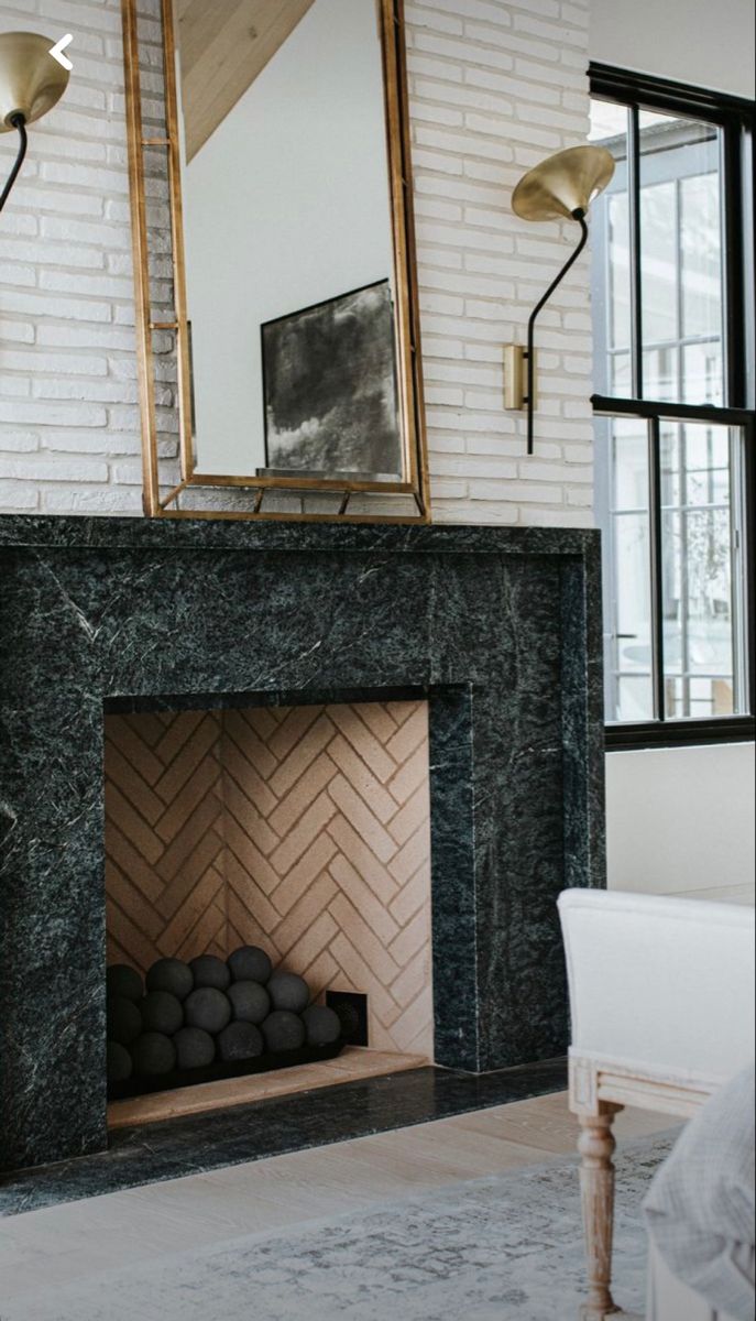 a living room with a fireplace and mirror on the wall