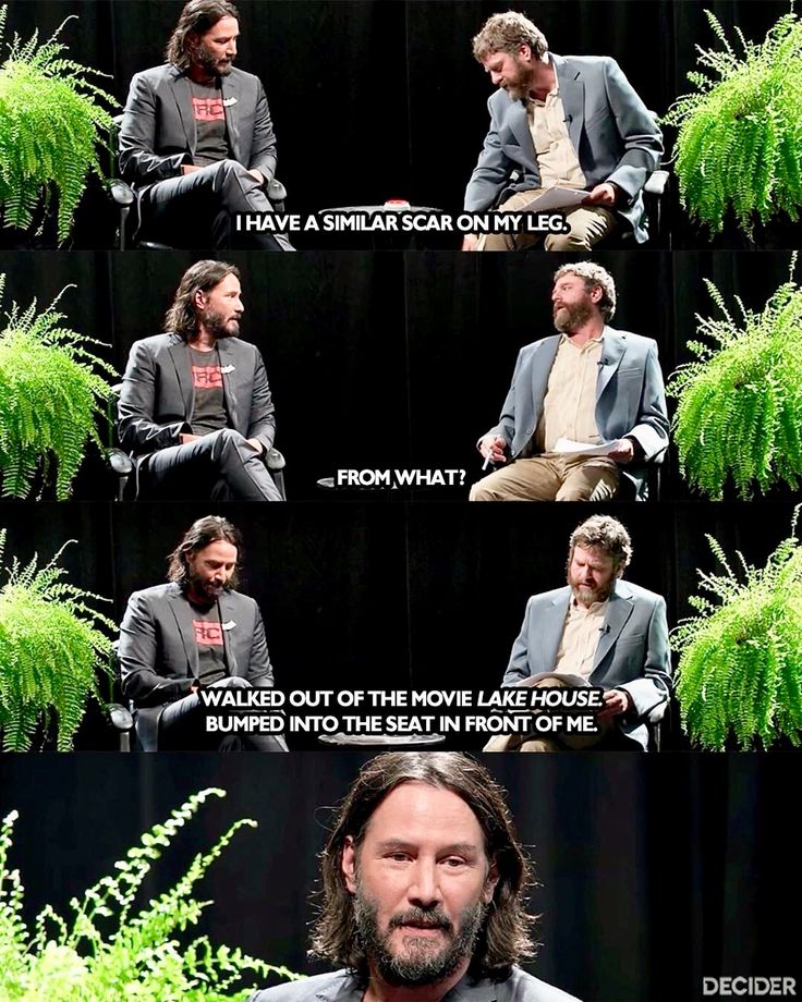 a man sitting in a chair next to a plant