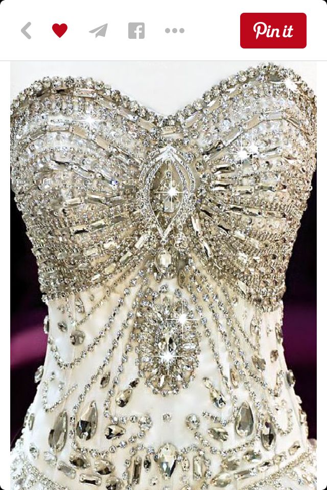 the back of a wedding dress with lots of beads on it