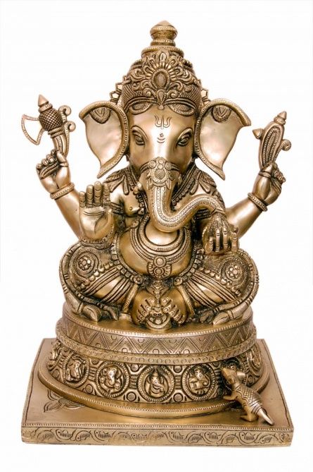 an elephant statue sitting on top of a gold plated stand with its trunk in the air