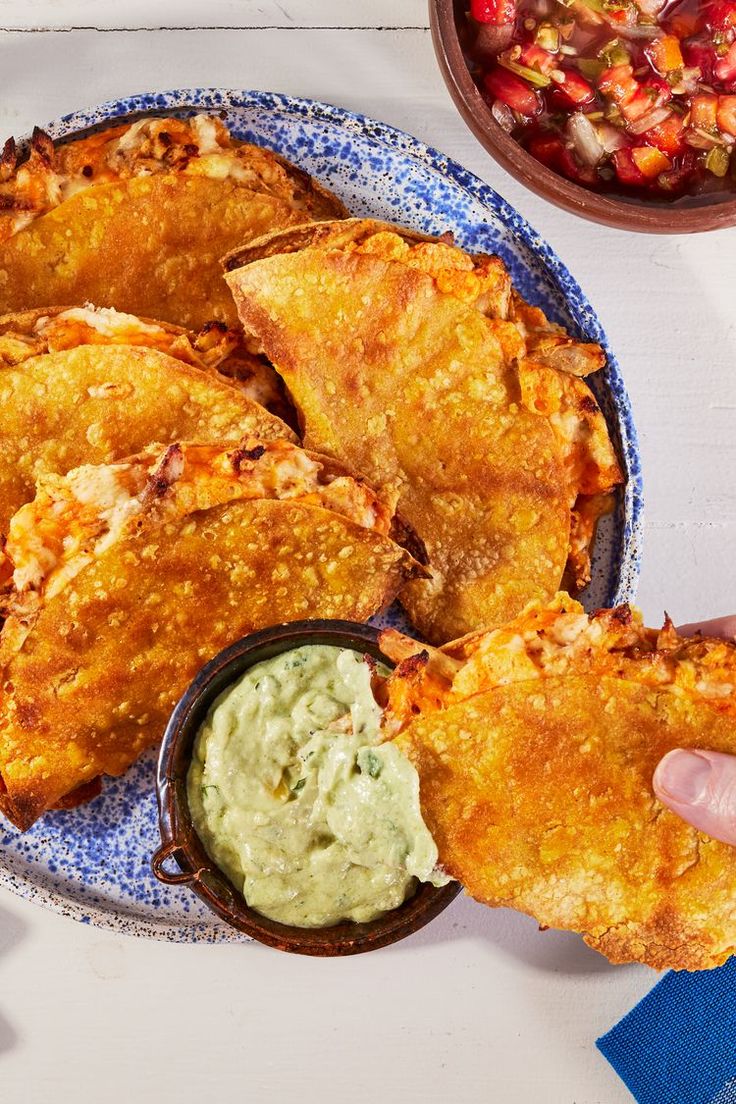 a plate full of fried food with dipping sauce