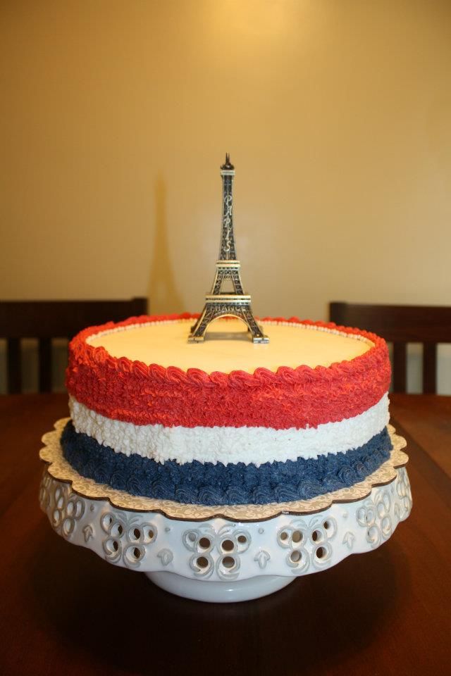 there is a cake that looks like the eiffel tower on top of it