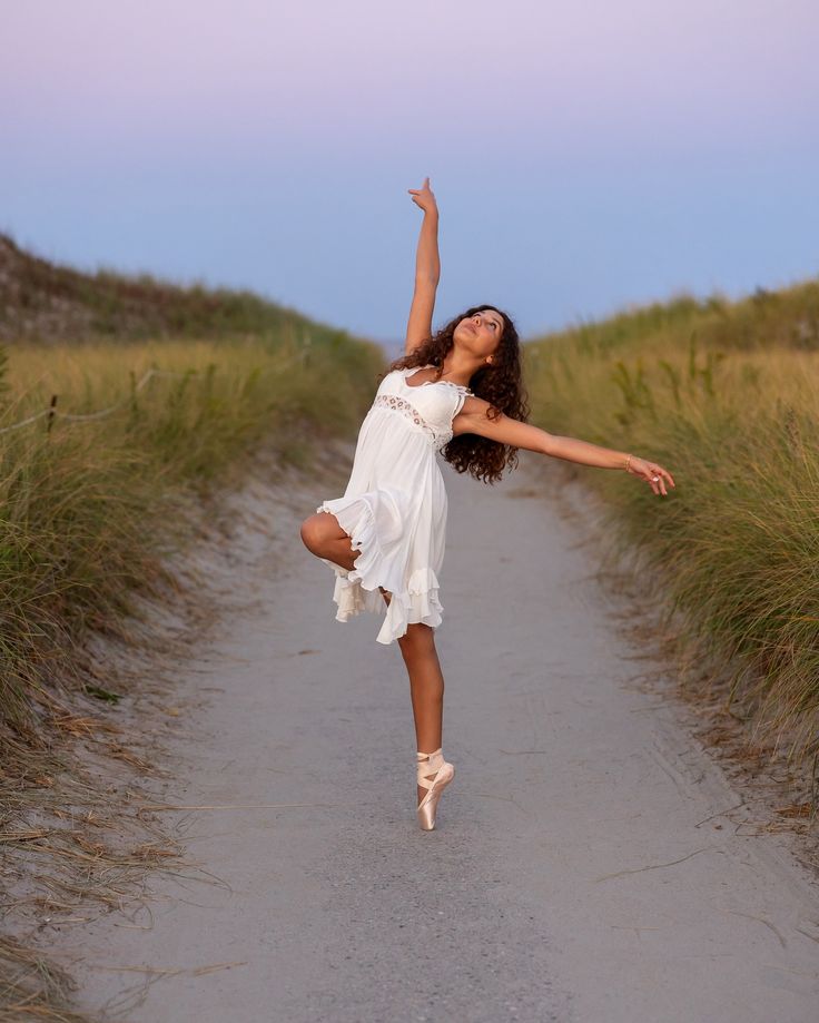 a woman is jumping in the air on a path