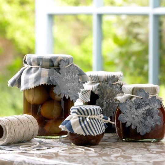 jars filled with food sitting on top of a table next to twine spools