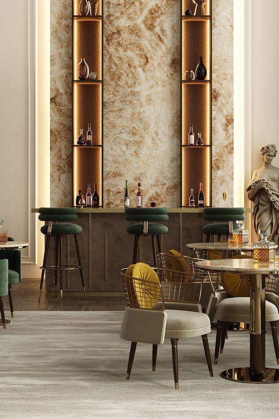 the interior of a modern bar with marble walls and gold trimmings on the shelves