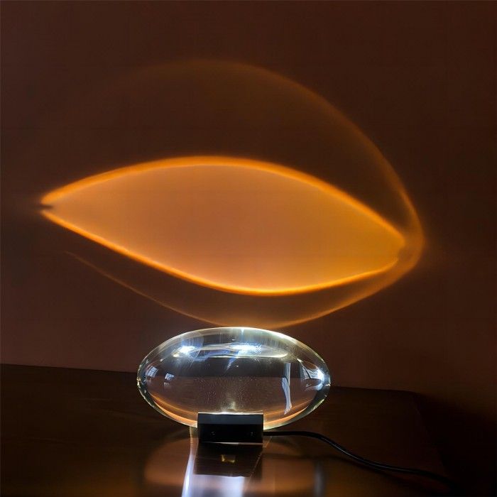 an illuminated glass object sitting on top of a table