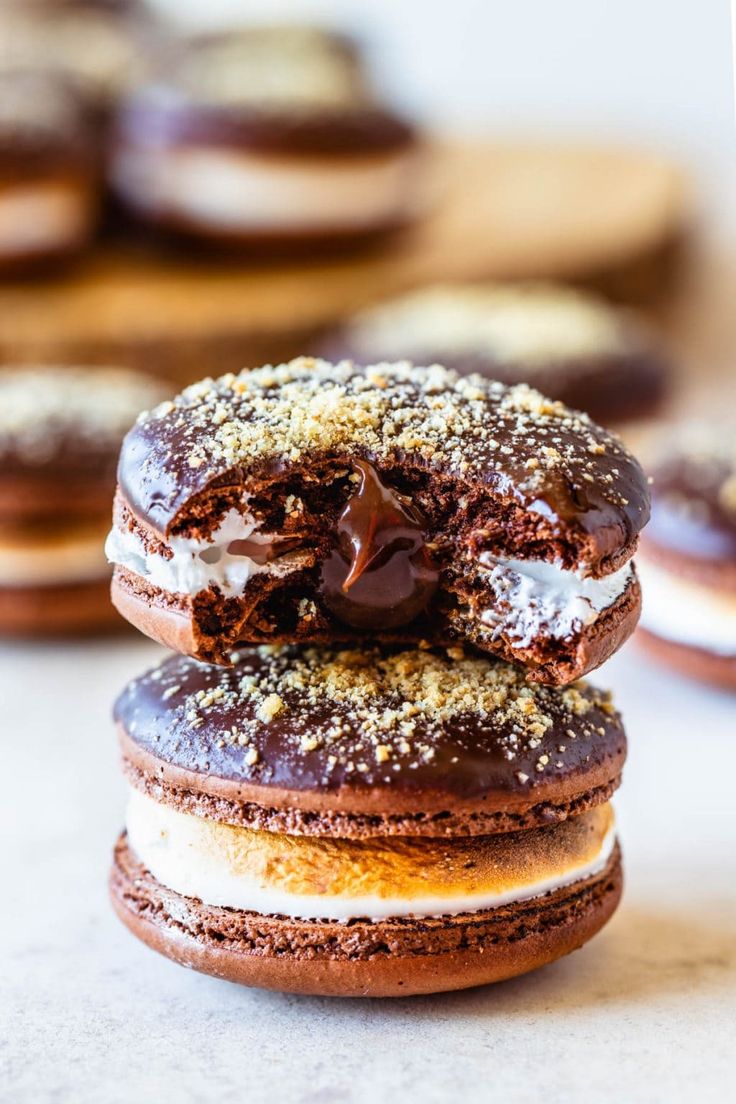 three chocolate covered donuts stacked on top of each other