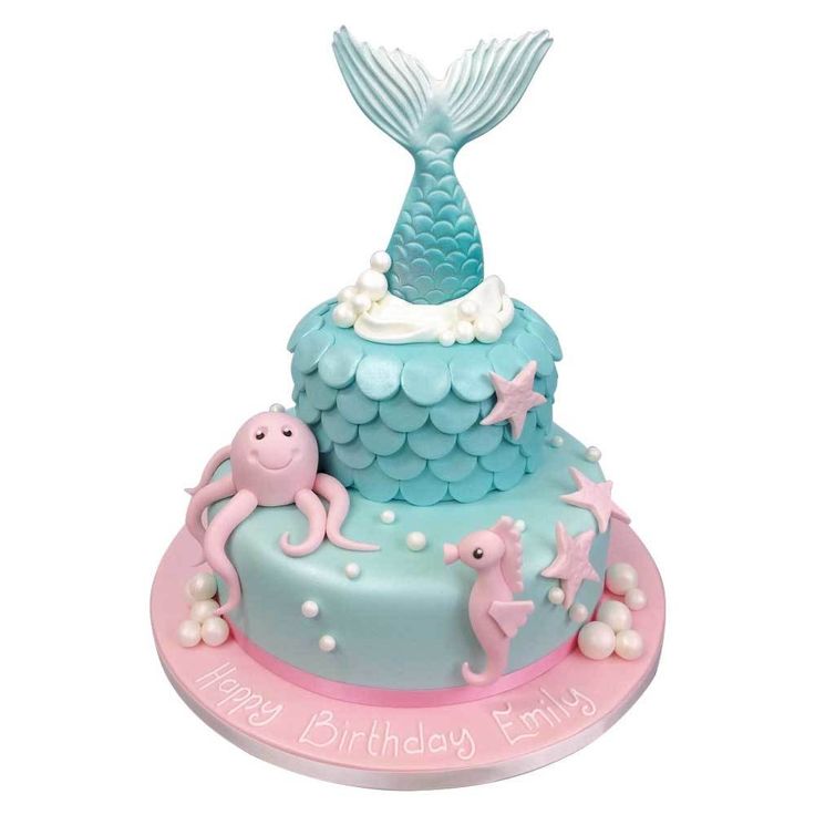 a blue and pink birthday cake with an under the sea theme on it's top