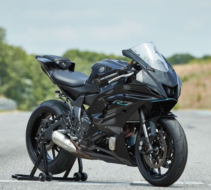 a black motorcycle is parked on the side of the road